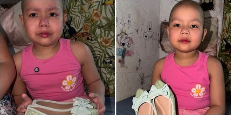 Sara, de 6 anos, segurando as sapatilhas